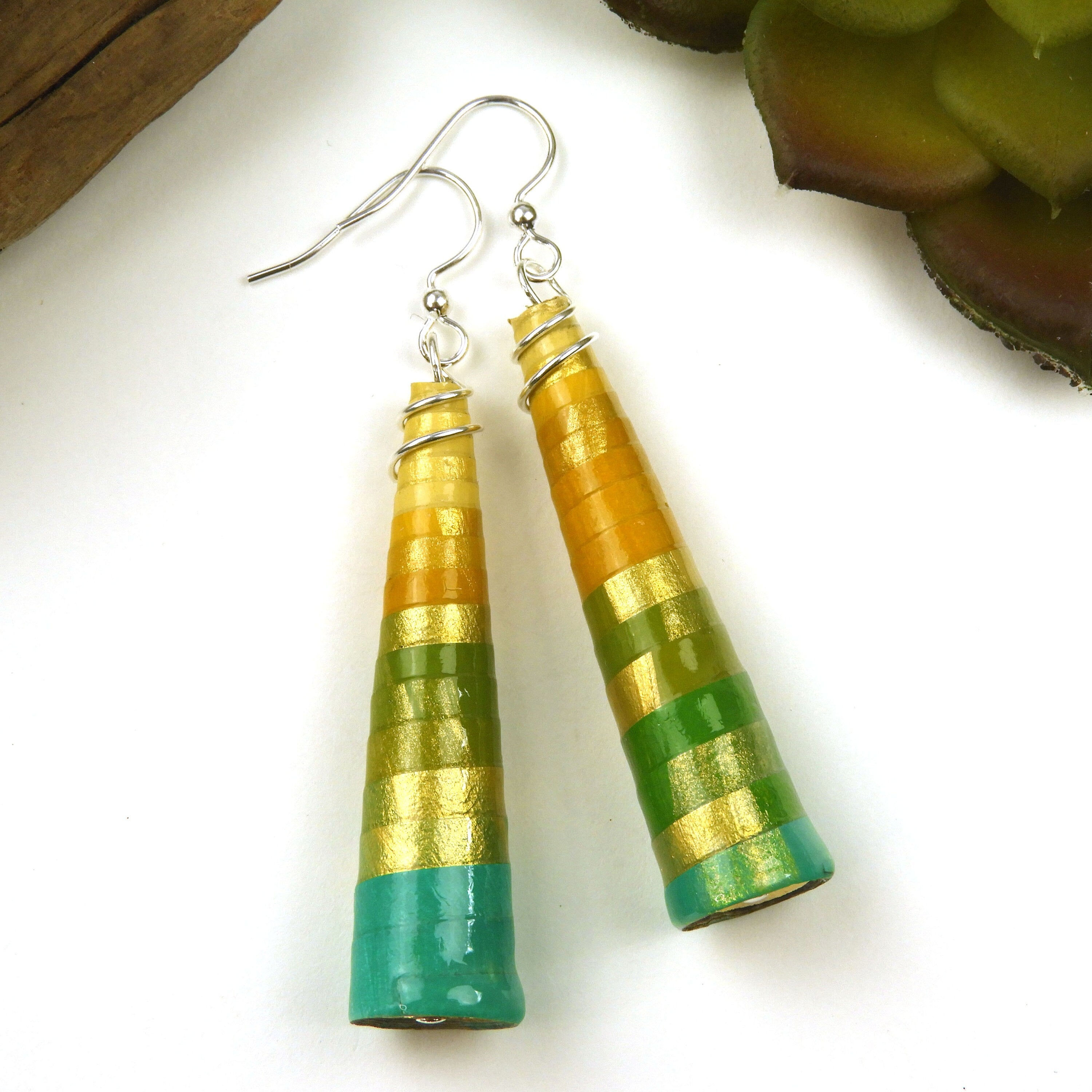 Yellow, mustard, and green ombre paper bead earrings on a white background.