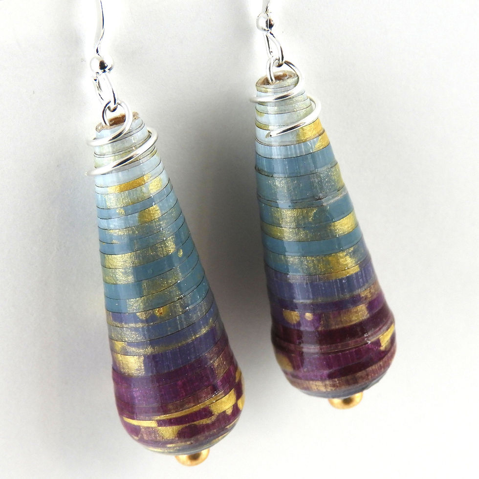 Blue, teal, and purple ombre paper bead earrings hanging on a white background.