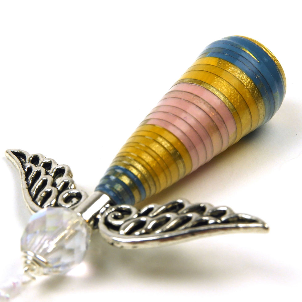 Thumbnail: Boho colors paper bead angel ornament laying diagonally, head first, on a white background.
