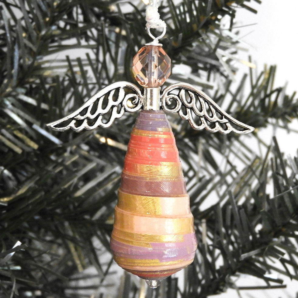 Lavender, gold, and pink paper bead angel ornament hanging from a Christmas tree.