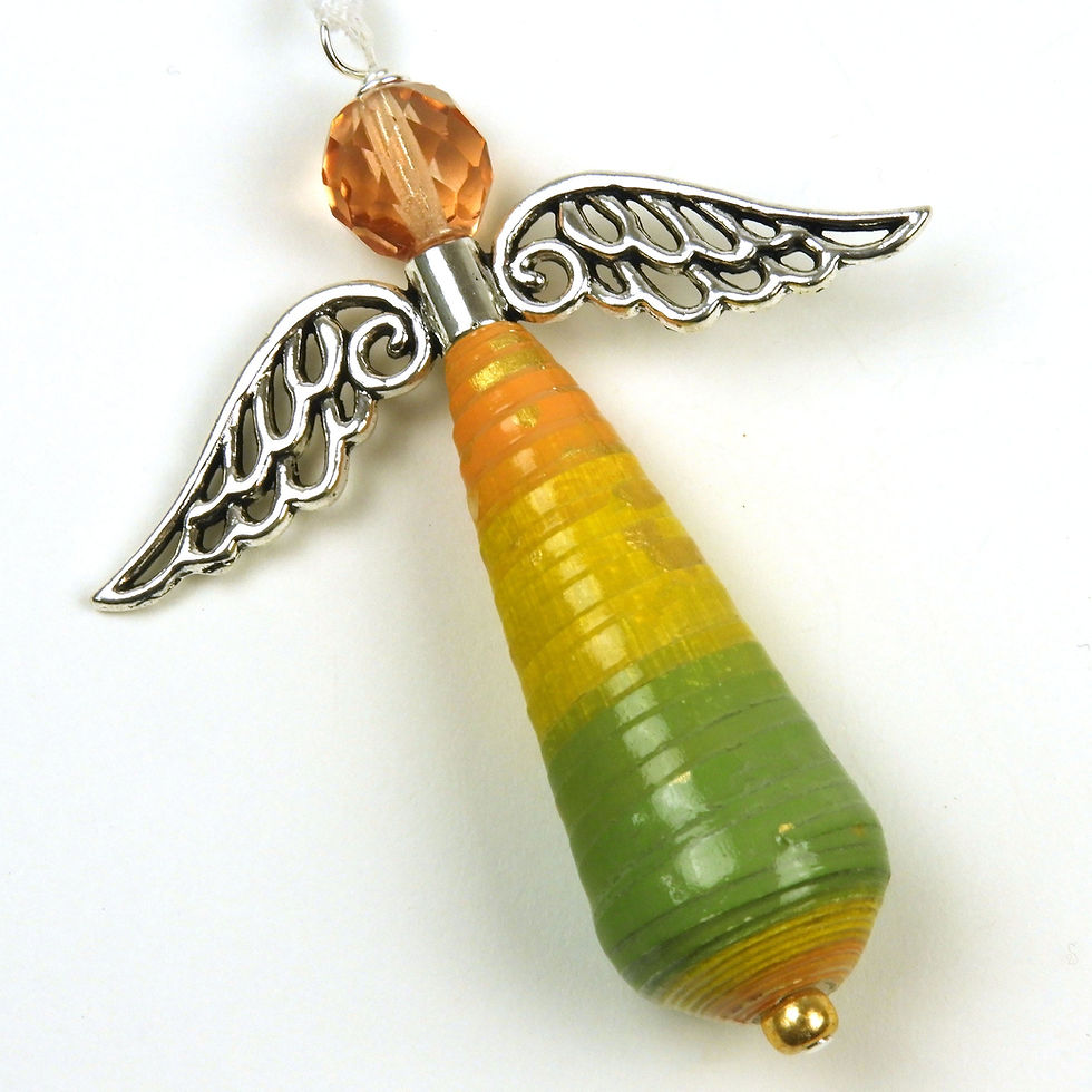 Orange, yellow, and green striped paper bead angel ornament laying diagonally on a white background.