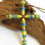 Thumbnail: Yellow, green, and blue ombre paper bead angel ornament on a piece of driftwood.
