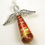 Thumbnail: Shades of red and gold paper bead angel ornament laying diagonally on a white background.