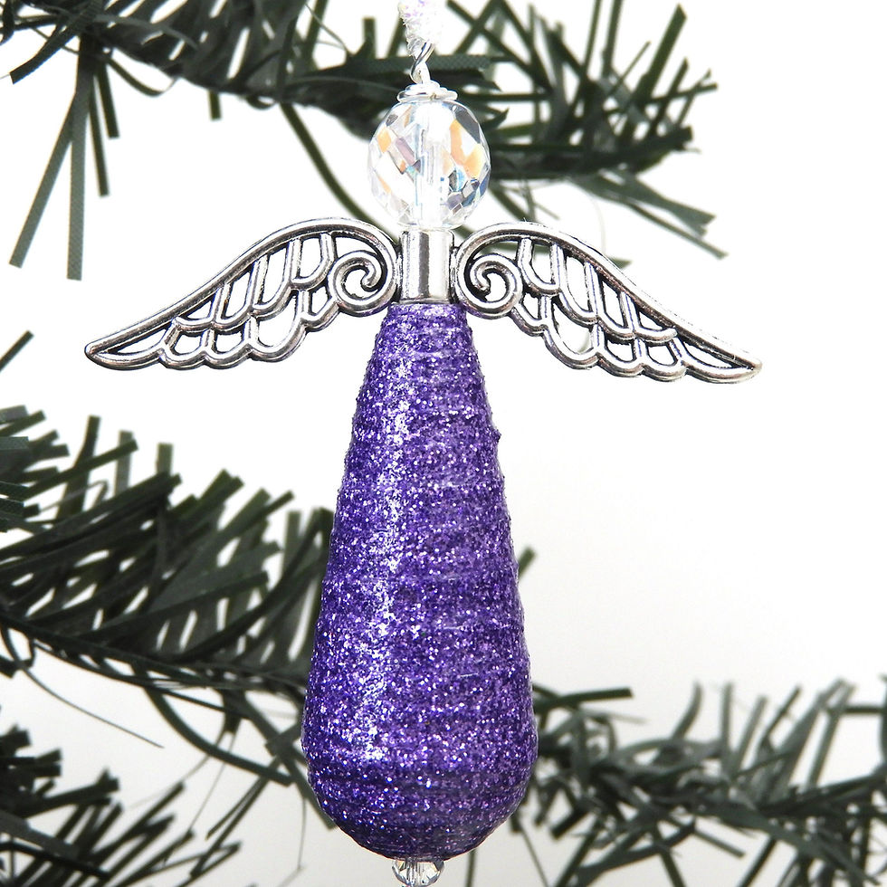 Thumbnail: Purple glitter paper bead angel ornament hanging from a Christmas tree.