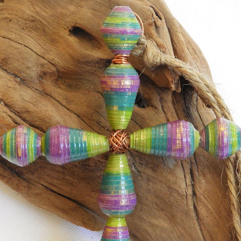 Thumbnail: Lime, teal, and purple ombre paper bead cross ornament on a piece of driftwood.