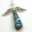 Thumbnail: Shades of blue paper bead angel ornament laying diagonally on a white background.