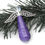 Thumbnail: Purple glitter paper bead angel ornament laying on Christmas tree garland.