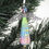 Thumbnail: Green, blue, and lavender paper bead angel ornament hanging from a Christmas tree.