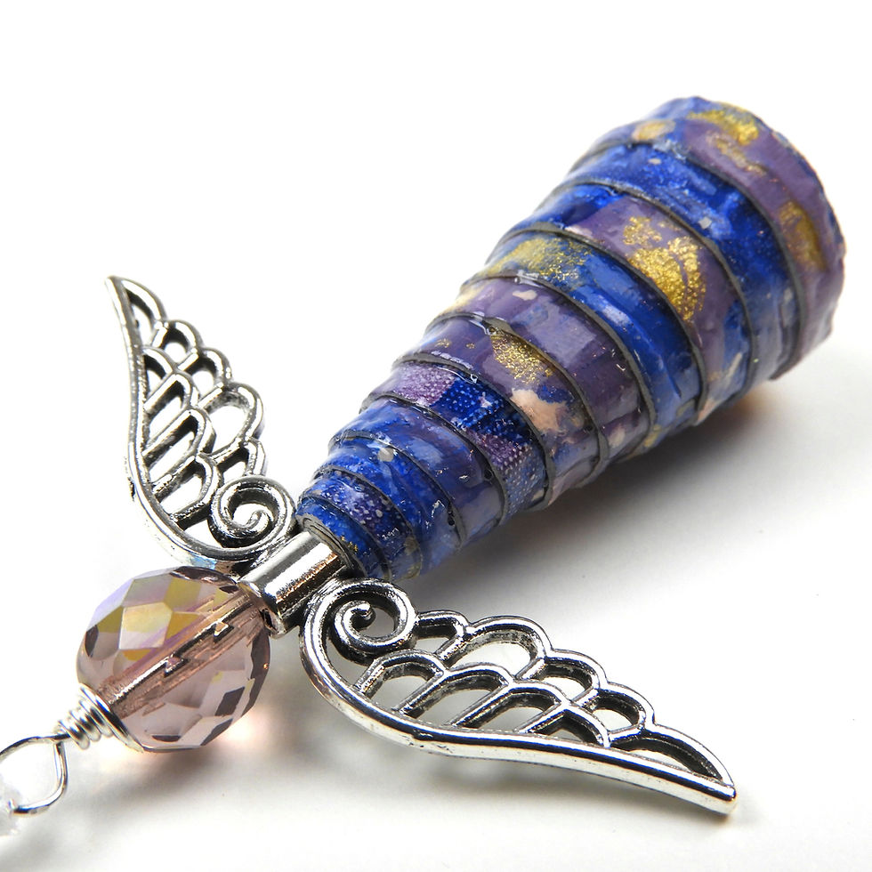 Thumbnail: Blue, purple, and gold paper bead angel ornament laying diagonally, head first, on a white background.