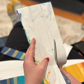 Cutting upcycled paper into strips for paper beads.