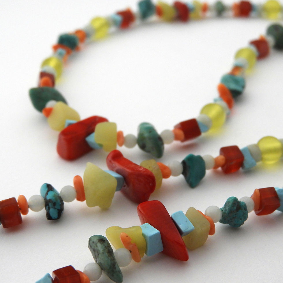Thumbnail: Natural stone and coral beaded eyeglass chain on a white background.
