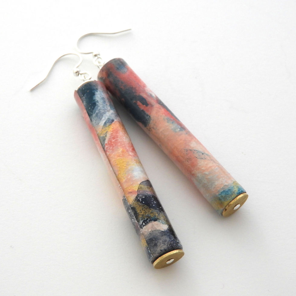 Coral, navy, white, and gold abstractly paper bead earrings on a white background.
