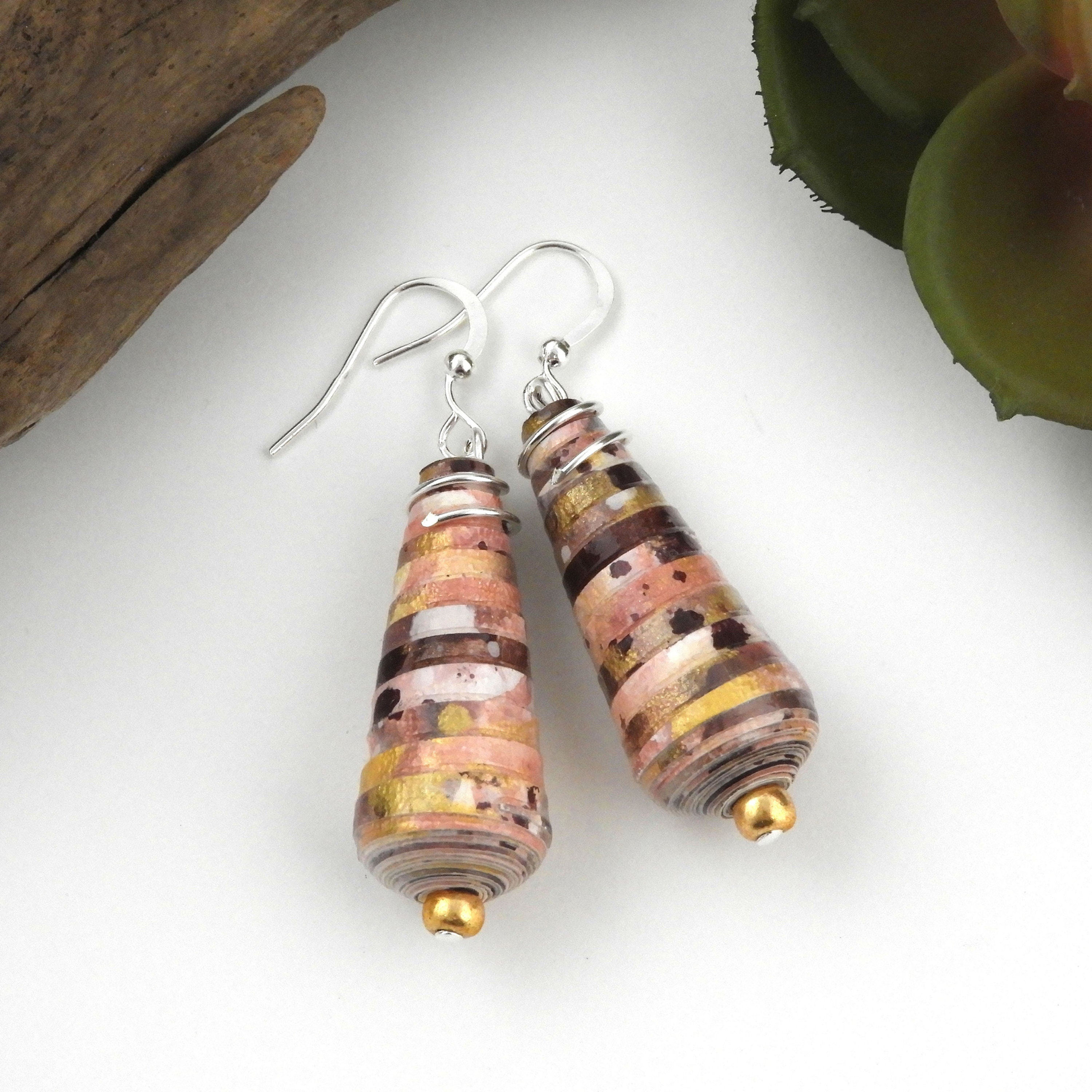 Pink, purple, white, and gold paper bead earrings on a white background.