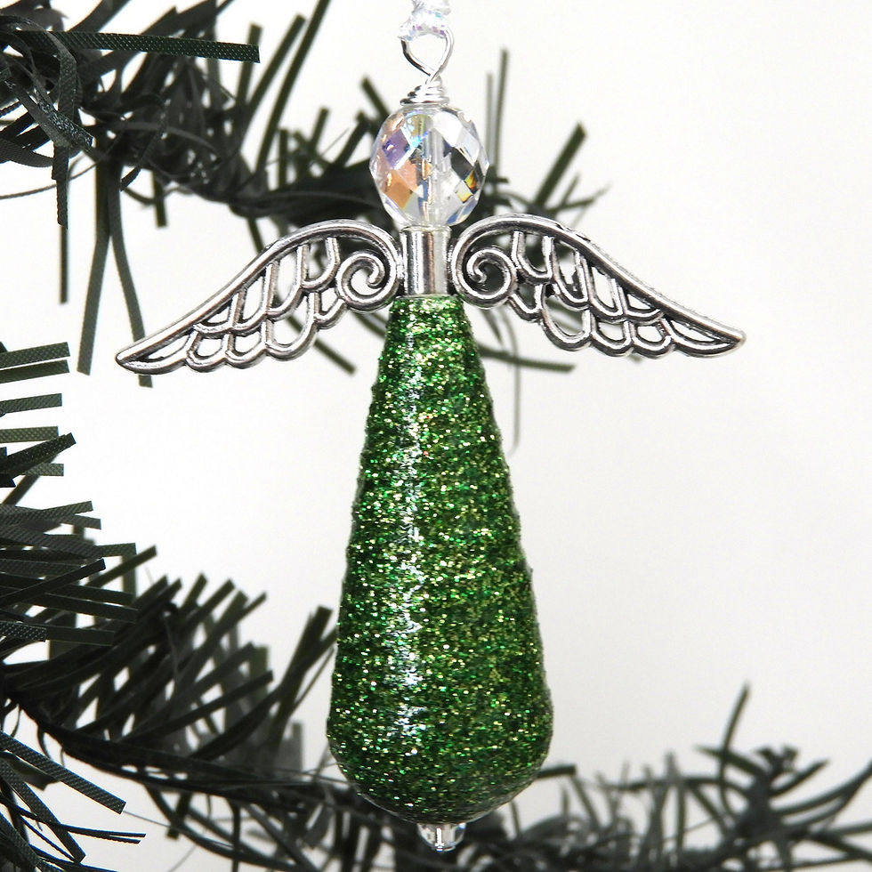 Thumbnail: Green glitter paper bead angel ornament hanging from a Christmas tree.