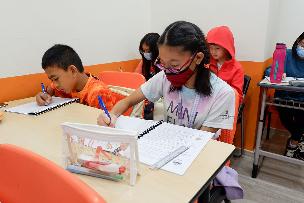 Teacher guiding pupils on strategies to improve PSLE Listening Comprehension skills.