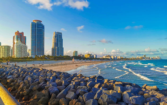 South Pointe Park Miami Beach – Ocean views with waves, a sandy beach, high-rise buildings, and a stone wall. Popular vantage point with panoramic views of the Atlantic Ocean.