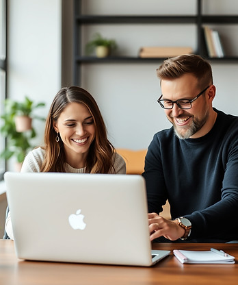 happy man and woman looking at a laptop.jpg