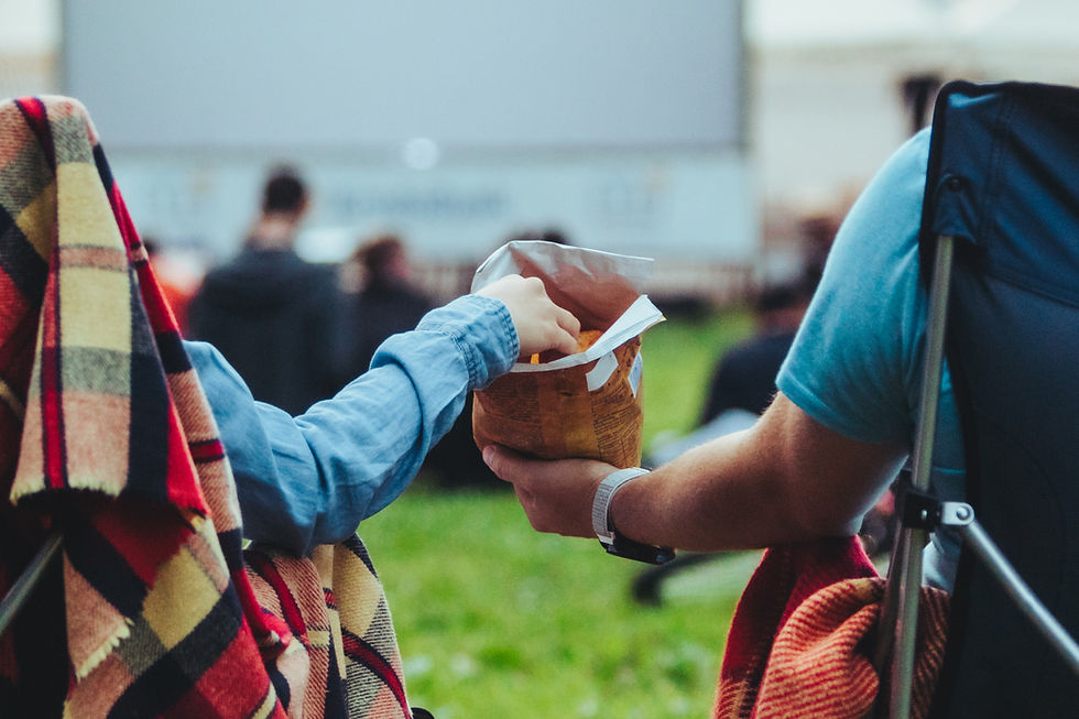 couple sharing snacks at an outdoor movie theater