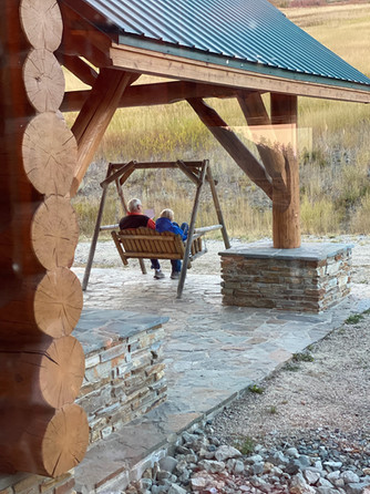 a couple sitting on a porch swing