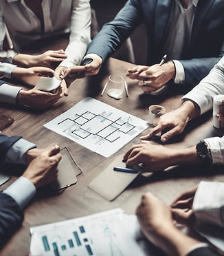 Group of professionals collaborating at a table, analyzing printed reports and charts to develop business strategy.