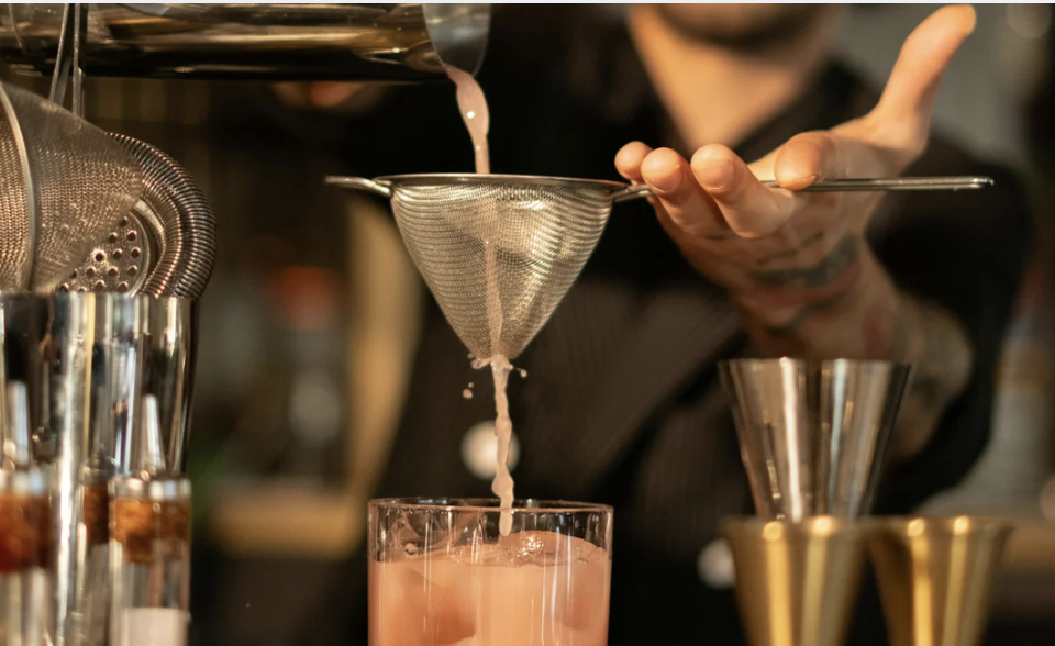 Couple learning mixology in a private cocktail class