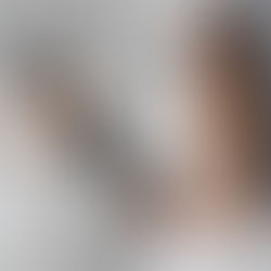 Bride trying on a custom wedding gown with the help of a bridal consultant.