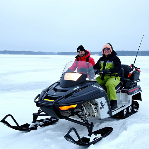 Snow mobile on iced lake with ice fishing gear with two people.jpg