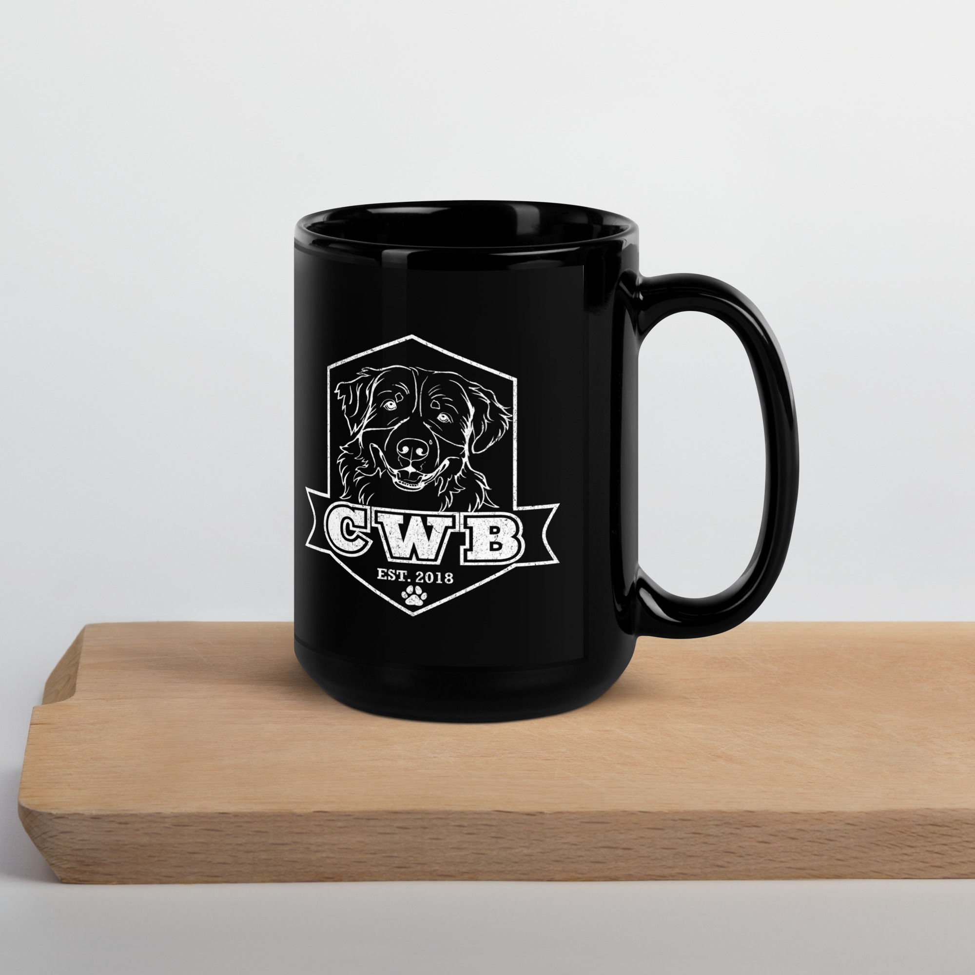CWB Alexa Logo Black Glossy Mug on a wooden surface