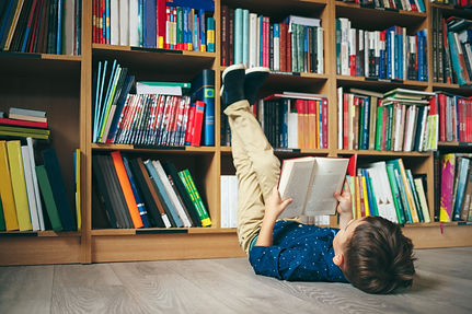 Boy laying on the floor with the feet up