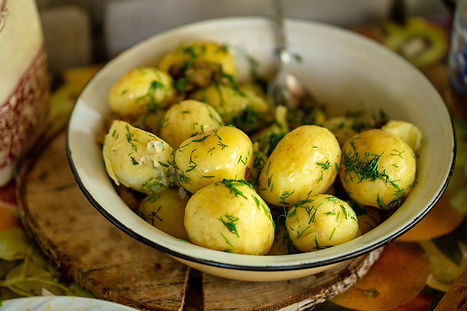 Fresh boiled new potatoes with fresh dill on rustic background.jpg