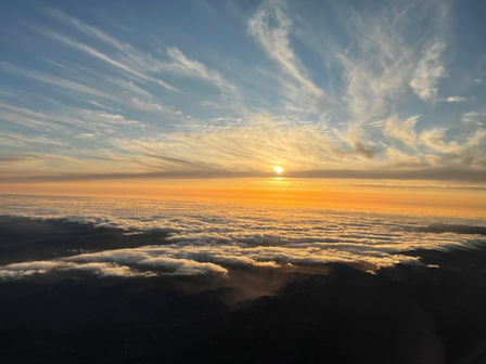 Cloud-level view of beautiful coastal sunset