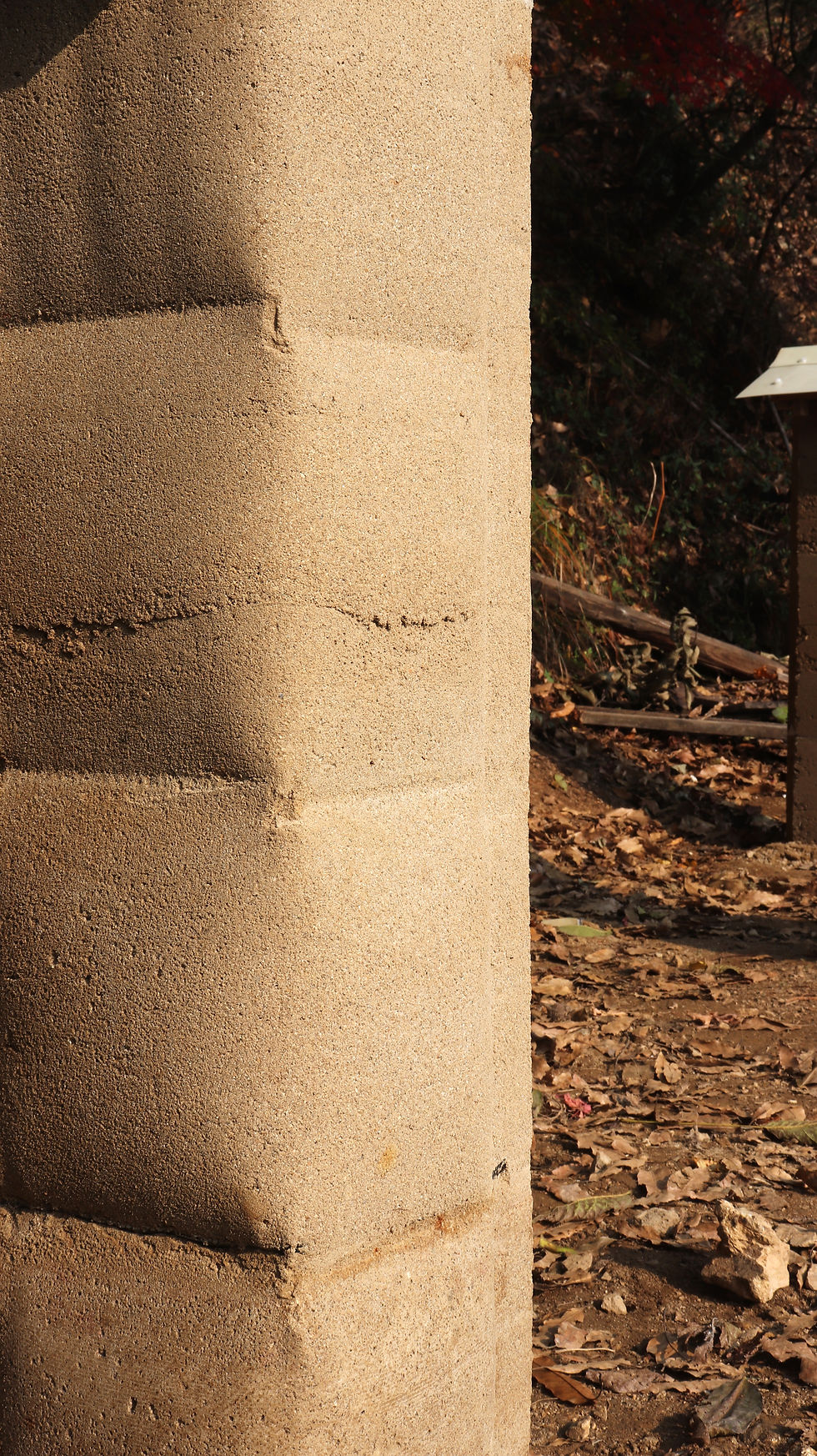 The rounded edge of fabric formed rammed earth wall