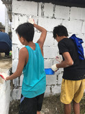 Local children of the Philippines were voluntarily painting the building