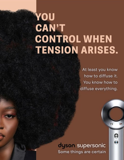 Print #4 of a Dyson SuperSonic advertising campaign. Theres a woman on the left with a large afro, a chocolatea brown background with a Dyson SuperSonic on the right, and ad copy throughout.