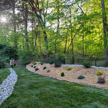 Complete garden installation with rock, shrubs and flowers.