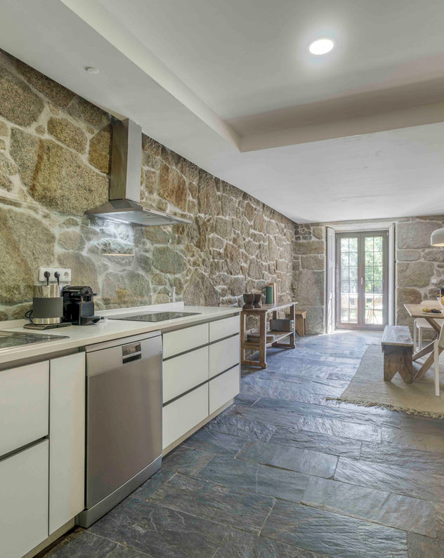 kitchen with garden access and natural furniture made of reclaimed vintage wood
