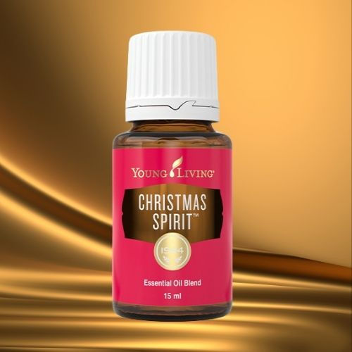 Ätherisches Öl Christmas Spirit von Young Living – rote Flasche auf goldenem Hintergrund, festliche Mischung für Freude, Geborgenheit und weihnachtliche Stimmung, erhältlich im Zukunfts-Impuls-Shop.
