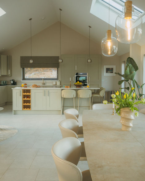 a kitchen with white cabinets and a wine rack