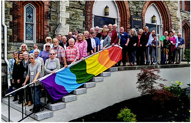 Group photo of The Park Church members standing before the front entrance.