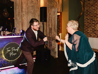 Tom Powell Music audience participation with a wedding guest at The Croft Hotel with DJ Booth in background