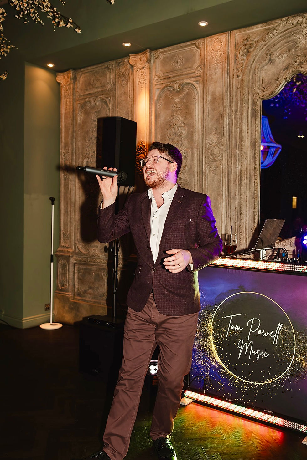 Tom singing at The Croft Hotel with Tom Powell Music DJ Booth in background