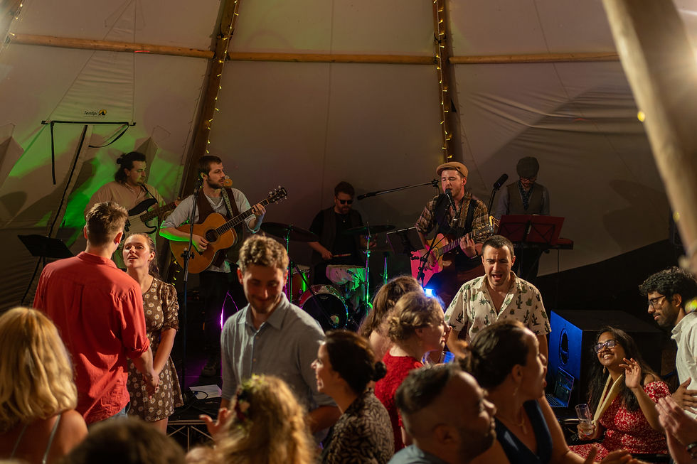 Eye-level view of a live acoustic wedding singer performing at a rustic venue