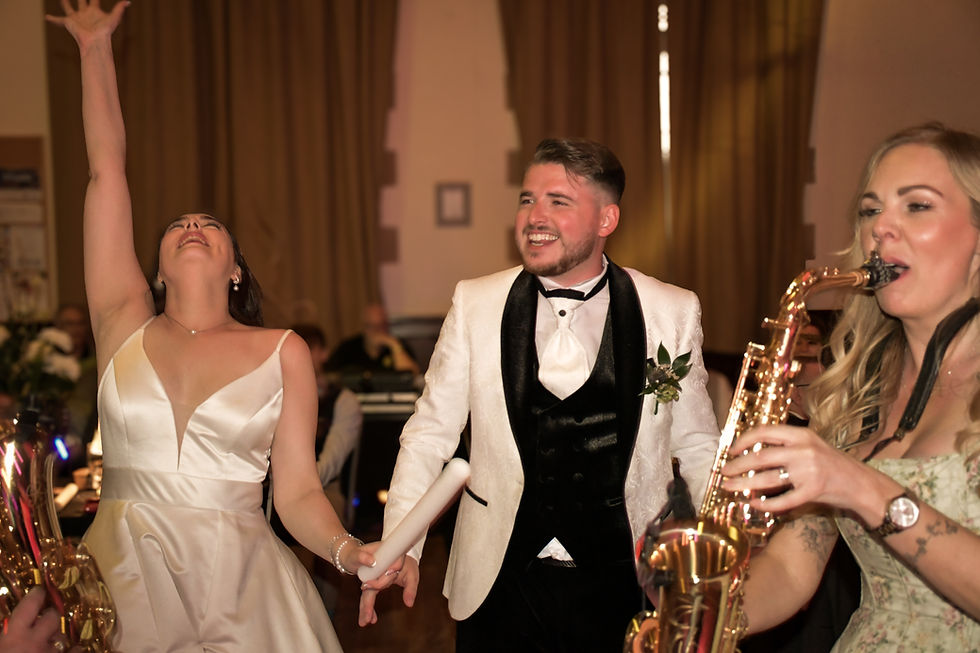 Eye-level view of a wedding singer performing an acoustic first dance song in a rustic venue