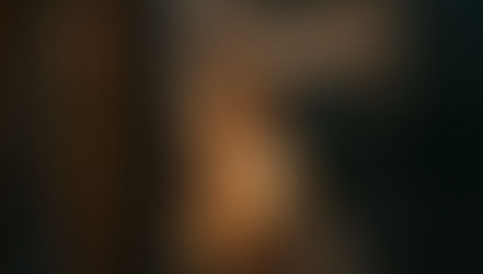 Warm light glowing through a rain-streaked window