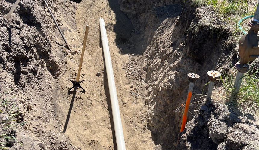 New 1” Water Main (Utility Grade Pipe) with PVC Sleeve Going Through Rock Bed
