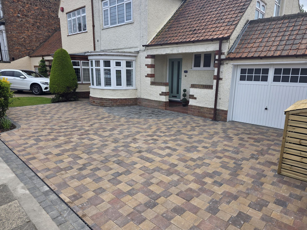 Detailed view of the block paving pattern and border edging installed around the front entrance area.