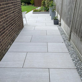 Curved sandstone pathway leading around the property