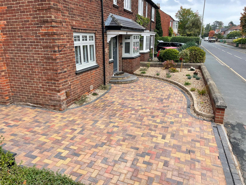 Front entrance with new stone steps, block paving, and a landscaped gravel garden.