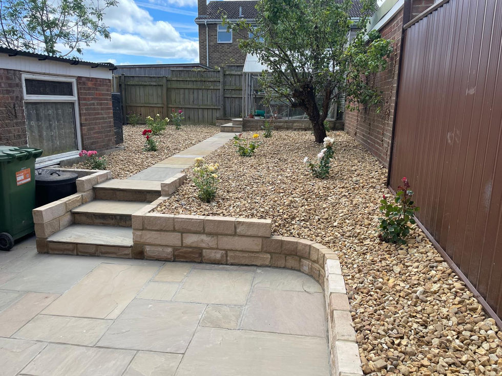 Natural stone pathway through decorative gravel planting beds