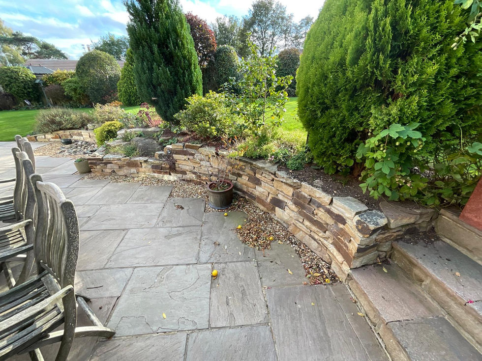 Garden showing original stone retaining walls and patio before alterations by Wilkinsons Landscapes